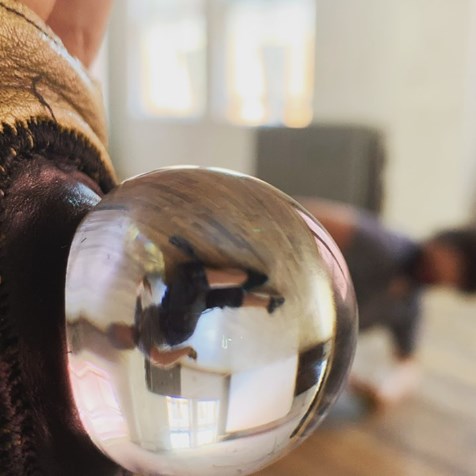 photo of me, DP by Alvin Tolentino; my body appears in the background, as well as inverted in a sphere of glass which Alvin's filming through; the glass is part of gloves we wear as costumes
